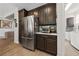 Kitchen area featuring stainless steel appliances and dark cabinets, with an adjacent laundry room at 4557 Bersaglio St, Las Vegas, NV 89135