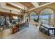 Elegant living room with fireplace, chandelier, built-in bookcase, and views of the water at 4557 Bersaglio St, Las Vegas, NV 89135