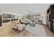 Bright living room with hardwood floors, plantation shutters, and views into the kitchen at 4557 Bersaglio St, Las Vegas, NV 89135