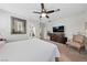 Main bedroom with large television, chair, and ensuite bathroom at 4557 Bersaglio St, Las Vegas, NV 89135