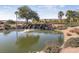 Scenic view of a pond with a waterfall feature and lush landscaping at 4557 Bersaglio St, Las Vegas, NV 89135