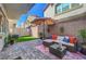 Spacious backyard patio with comfortable outdoor seating, artificial turf, and a shade umbrella at 4640 Flower Moon Ave # 102, North Las Vegas, NV 89084