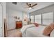 Comfortable bedroom with a ceiling fan, dresser and plenty of natural light from the three large windows at 4640 Flower Moon Ave # 102, North Las Vegas, NV 89084