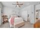 Comfortable bedroom featuring a bed with a ceiling fan, closet, and a mirror at 4640 Flower Moon Ave # 102, North Las Vegas, NV 89084