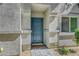 Cozy townhome front entrance with welcome mat, stone walkway and manicured landscaping at 4640 Flower Moon Ave # 102, North Las Vegas, NV 89084