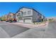 Street view of townhome with attached garages, manicured landscaping, and red-curbed road at 4640 Flower Moon Ave # 102, North Las Vegas, NV 89084