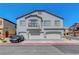 Charming townhome with a well-maintained exterior, garages, and a small balcony at 4640 Flower Moon Ave # 102, North Las Vegas, NV 89084