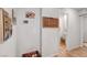 Hallway features neutral walls and tasteful decor leading to the bathroom and laundry area at 4640 Flower Moon Ave # 102, North Las Vegas, NV 89084