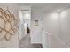 Upstairs hallway with neutral carpet leading to various rooms, creating an open feel at 4640 Flower Moon Ave # 102, North Las Vegas, NV 89084