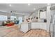 Modern kitchen flows into the living area, with a view of the staircase at 4640 Flower Moon Ave # 102, North Las Vegas, NV 89084