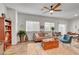 Bright living room with a ceiling fan, plants, and a cozy seating arrangement at 4640 Flower Moon Ave # 102, North Las Vegas, NV 89084