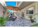 Relaxing patio features stone pavers, seating, and privacy fence at 4640 Flower Moon Ave # 102, North Las Vegas, NV 89084