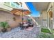 Cozy patio with paved flooring, outdoor seating, and shade umbrella for relaxing at 4640 Flower Moon Ave # 102, North Las Vegas, NV 89084