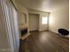 Living room featuring wood-look laminate floors, a corner fireplace, and a large sliding glass door at 4730 E Craig Rd # 1106, Las Vegas, NV 89115