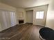 Living room featuring wood-look laminate floors, a corner fireplace, and a large sliding glass door at 4730 E Craig Rd # 1106, Las Vegas, NV 89115