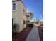 A side exterior view showcasing the building architecture, balcony and landscaping at 4854 Nara Vista Way # 201, Las Vegas, NV 89103