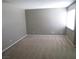 Neutral living room with a window, beige carpet, and neutral walls, ready for personalization at 574 Roxella Ln # C, Las Vegas, NV 89110