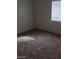 Neutral carpeted bedroom with a window allowing natural light to fill the space at 5750 E Hacienda Ave # 202, Las Vegas, NV 89122