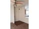 Apartment entryway with a ceiling fan and lighting, dark wood flooring and a glimpse of the kitchen at 5750 E Hacienda Ave # 202, Las Vegas, NV 89122