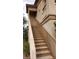 Exterior stairs leading to a second-story apartment with neutral paint colors and a brown metal banister at 5750 E Hacienda Ave # 202, Las Vegas, NV 89122