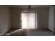 Bright living room featuring sliding glass doors with vertical blinds for added privacy at 5750 E Hacienda Ave # 202, Las Vegas, NV 89122