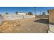 Large, empty backyard with a dirt ground, block wall, and aged yellow shed at 6120 Cairo Cir, Las Vegas, NV 89107