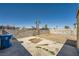 Backyard features a block wall, cracked concrete, some greenery, and an aged yellow shed at 6120 Cairo Cir, Las Vegas, NV 89107