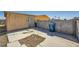 Backyard with a concrete patio, block wall, and an aged yellow shed, partially covered in peeling paint at 6120 Cairo Cir, Las Vegas, NV 89107