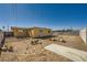 Expansive backyard featuring a dirt ground, weathered fence, aged yellow shed, and open sky at 6120 Cairo Cir, Las Vegas, NV 89107