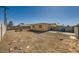 Large, empty backyard with a dirt ground, block wall, and aged yellow shed at 6120 Cairo Cir, Las Vegas, NV 89107