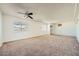 Large bedroom with tan carpet, ceiling fan, and neutral walls at 6120 Cairo Cir, Las Vegas, NV 89107