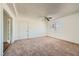 Bright bedroom features neutral carpet, a window with blinds, white walls, ceiling fan, and closet at 6120 Cairo Cir, Las Vegas, NV 89107