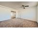 Bedroom with neutral carpet, white walls, a ceiling fan, and view into other rooms at 6120 Cairo Cir, Las Vegas, NV 89107