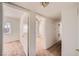 Open hallway with neutral carpet and white walls, leading to multiple rooms with natural light at 6120 Cairo Cir, Las Vegas, NV 89107