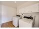 Bright laundry room with white appliances and storage cabinets at 6120 Cairo Cir, Las Vegas, NV 89107