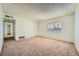 Bright living room with tan carpet and neutral walls at 6120 Cairo Cir, Las Vegas, NV 89107