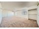 Spacious living room featuring plush carpeting, bright windows, and built-in shelving at 6120 Cairo Cir, Las Vegas, NV 89107