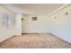 Bright living room featuring neutral walls, plush carpeting, a large window, and updated light fixtures at 6120 Cairo Cir, Las Vegas, NV 89107