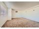 Bright living room featuring neutral walls, plush carpeting and a large window at 6120 Cairo Cir, Las Vegas, NV 89107