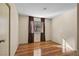 Cozy bedroom with hardwood floors, a window with curtains and a closet providing a comfortable and stylish living space at 6217 Sadler Dr, Las Vegas, NV 89130