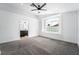 Bright Primary bedroom with large window, ceiling fan, neutral-colored carpet and connecting bathroom at 6505 Moon Roses Ct, Las Vegas, NV 89108