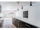 Modern kitchen island with black cabinets, white countertop, and pendant lights above the kitchen island at 6505 Moon Roses Ct, Las Vegas, NV 89108