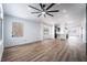 Bright living room with hardwood floors leading to an open kitchen and large windows at 6505 Moon Roses Ct, Las Vegas, NV 89108