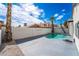 Backyard featuring a private pool, surrounded by palm trees and a block wall for added privacy at 6505 Moon Roses Ct, Las Vegas, NV 89108