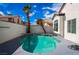 Sparkling pool offering a refreshing retreat, complemented by palm trees, blue skies, and a tidy patio at 6505 Moon Roses Ct, Las Vegas, NV 89108