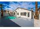 Residential pool with a pristine pool surrounded by landscaping, creating a serene backyard oasis at 6505 Moon Roses Ct, Las Vegas, NV 89108