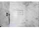 Stylish shower features marble-like tile and built-in niche at 6505 Moon Roses Ct, Las Vegas, NV 89108