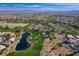 Stunning aerial view of a golf course community showcasing lush landscaping and serene lakes at 74 Harbor Coast St, Las Vegas, NV 89148