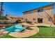 Relaxing backyard with a refreshing pool, patio area, and lush artificial turf for low maintenance in the desert at 74 Harbor Coast St, Las Vegas, NV 89148