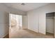 Bright bedroom with neutral carpet and a closet, and a view of the staircase and entryway at 74 Harbor Coast St, Las Vegas, NV 89148